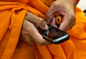 monk buddhist mobile phone checking facebook news 300x208 monk buddhist mobile phone checking facebook news